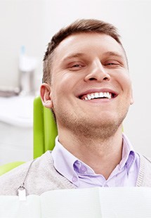 Smiling man sitting in dental office 