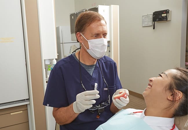 Dotor Warwick working with dental patient