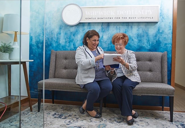 Smiling dental team member working with dentistry patient