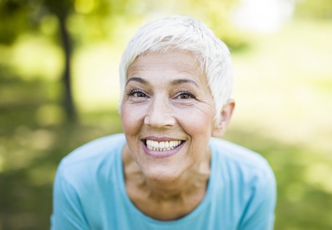 woman with dentures showing off her smile