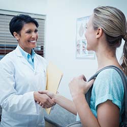 Emergency dentist in Pittsburgh shaking hands with a patient