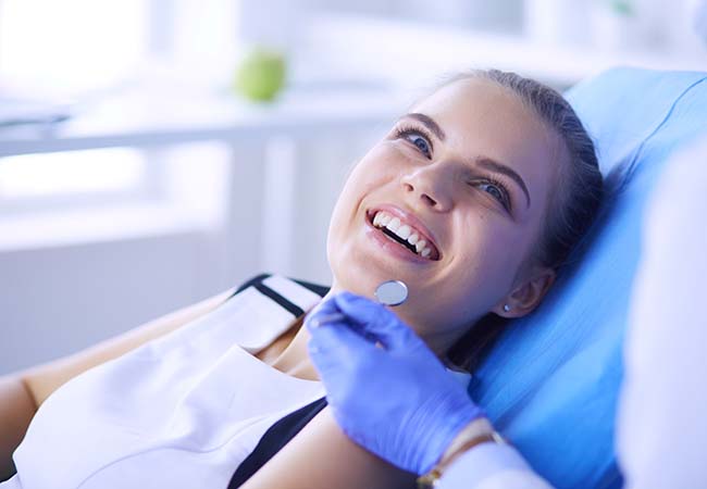 Woman smiling while visiting an emergency dentist in Pittsburgh