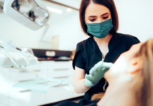 Dentist examining patient’s tooth during visit 