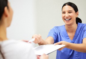 Patient and dental staff member conversing