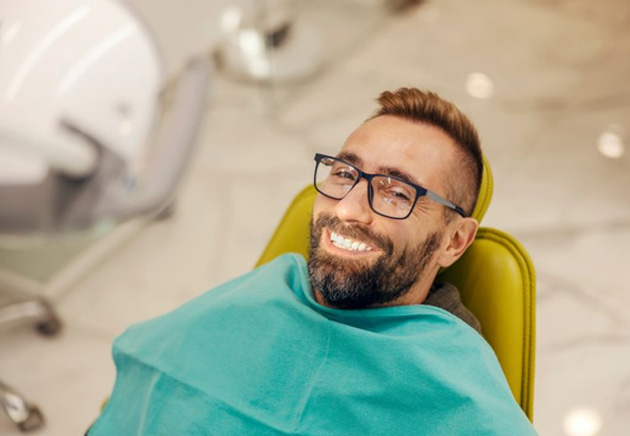Happy dental patient in treatment chair