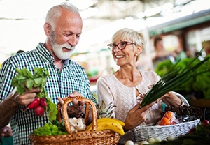 senior man and woman buying fresh fruits and vegetables