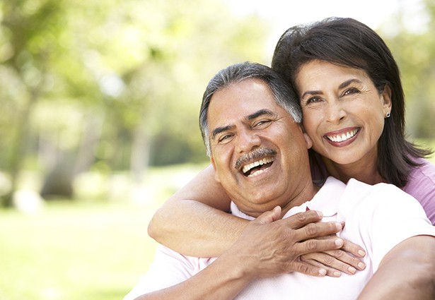 Smiling couple sitting outside