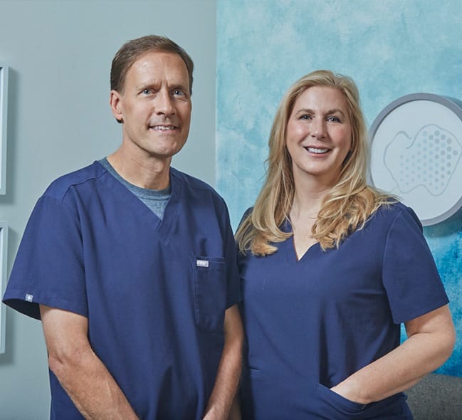 Doctors John and Joyce Warwick smiling in downtown Pittsburgh dental office