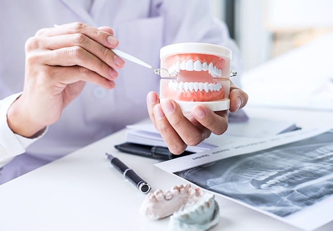 Dentist showing patient a smile model