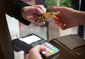 Man handing woman credit card