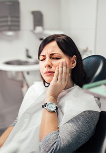 Woman with toothache at dentist's office in New Bedford