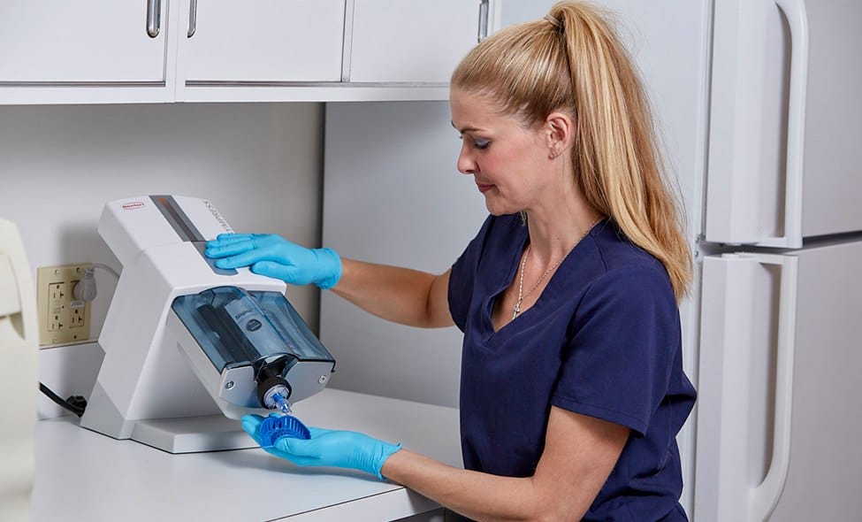 Dental team member using a chairside dental treatment tool