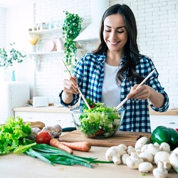 Woman making healthy meal to prevent dental emergencies in Pittsburgh