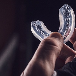 Athlete holding mouthguard in Pittsburgh