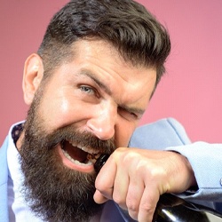 Man opening bottle with teeth