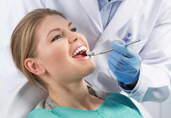 Woman receiving preventive dentistry checkup