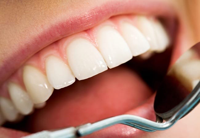 Patient receiving an exam after gum disease treatment