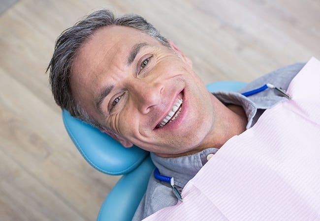 Man smiling after root canal therapy