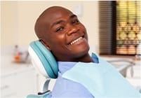 Smiling man at dental office for preventive dentistry