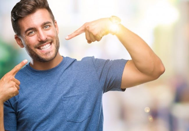 man pointing to his smile with veneers in Pittsburgh 