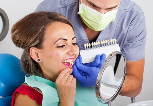 woman in red shirt trying on veneers in Pittsburgh