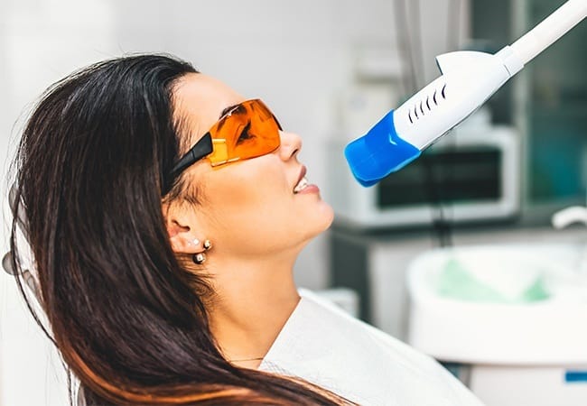 Patient receiving in office teeth whitening treatment