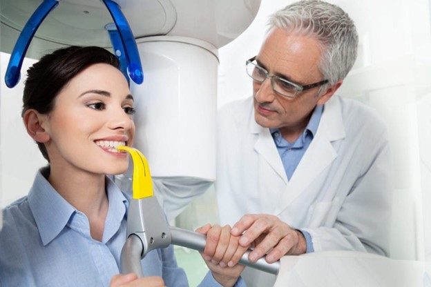 patient at dentist using cone beam scanner