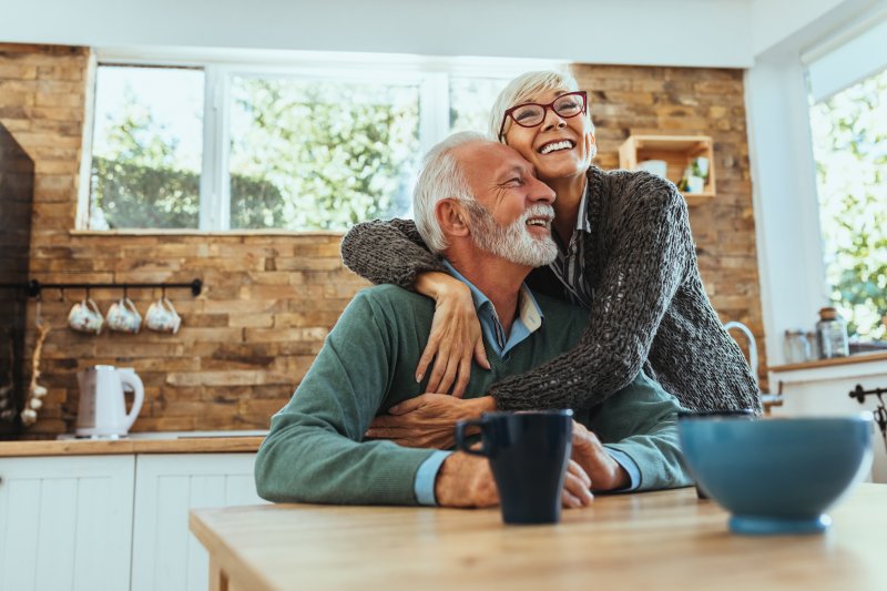 Older couple embracing with dentures