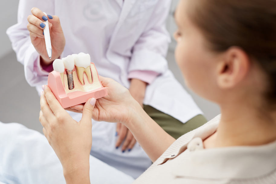 Dentist showing patient dental implants
